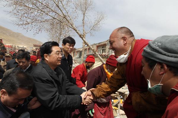 Chinese President Hu Jintao shakes hands with a local resident in the Tibetan Autonomous Prefecture of Yushu, northwest China's Qinghai Province, April 18, 2010