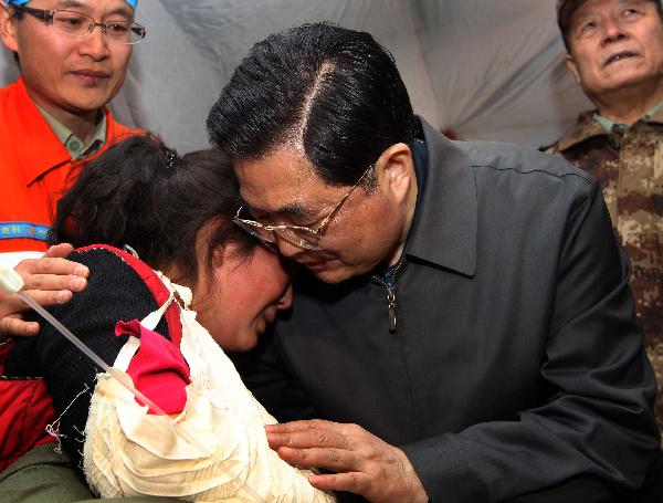 Chinese President Hu Jintao (R front) gives a hug to injured student Zhoema of Tibetan ethnic group during his visit to those injured in the quake receiving treatment at as stadium in the Tibetan Autonomous Prefecture of Yushu, northwest China's Qinghai Province, April 18, 2010. 