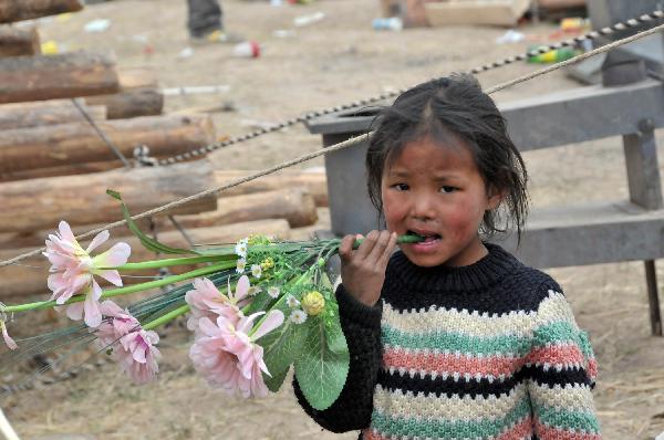 One of the daughters of Ngot (transliterated) plays in Gyegu Town of the Tibetan Autonomous Prefecture of Yushu, northwest China&apos;s Qinghai Province, April 17, 2010. Ngot, a 45-year-old man living in Gyegu Town, lost his wife in the fatal earthquake that struck here early Wednesday. He planned to do business in the future to raise his six daughters, aged from one and a half to 15.