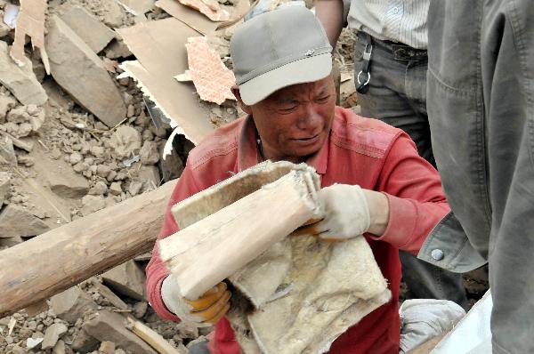 Ngot (transliterated) looks for belongings on the debris of his home in Gyegu Town of the Tibetan Autonomous Prefecture of Yushu, northwest China&apos;s Qinghai Province, April 17, 2010. Ngot, a 45-year-old man living in Gyegu Town, lost his wife in the fatal earthquake that struck here early Wednesday. He planned to do business in the future to raise his six daughters, aged from one and a half to 15.