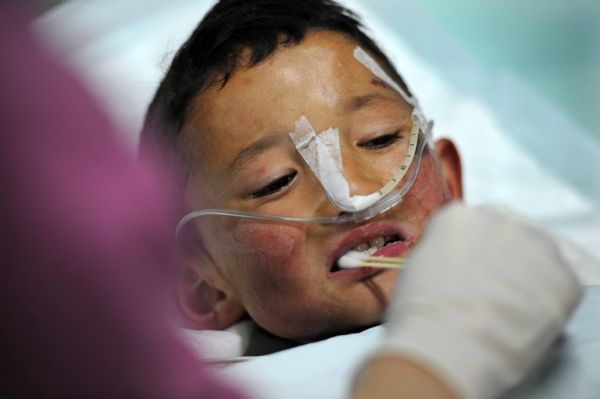 Injured boy Gajiao receives medical treatment at the Huaxi Hospital Affiliated to Sichuan University in Chengdu, southwest China&apos;s Sichuan Province, April 18, 2010. Nine-year-old Gajiao and his elder sister Qiuqu were transfered to the hospital after they were injured in the 7.1-magnitude earthquake.