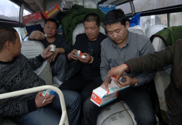 Farmers from China&apos;s Hebei Province take medicine for altitude sickness after they arrive in the quake-hit Yushu Tibetan Autonomous Prefecture of northwest China&apos;s Qinghai Province, April 19, 2010. They set off on April 15 and purchased 170 quilts, 78 cotton-padded clothes and three tents on their way to the quake-hit area.