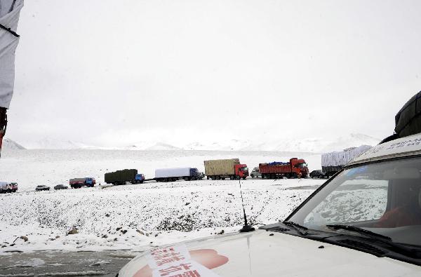 A long fleet of cargo vehicles transports quake-relief materials to Yushu, northwest China's Qinghai Province, April 19, 2010. The quake-relief materials were continuously transported to the disaster areas despite the snowfall and frozen road surface.