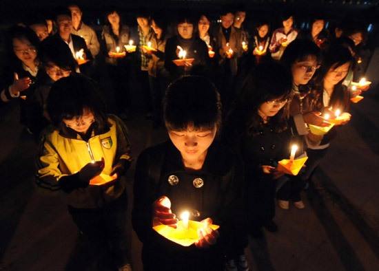 Students at Nankai University in Tianjin municipality hold a candlelight vigil in memory of Yushu earthquake victims on Tuesday, April 20, 2010. 
