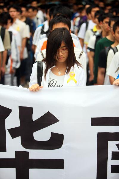 College students mourn for the victims of Yushu earthquake, in Guangzhou, capital south China's Guangdong Province, April 21, 2010.