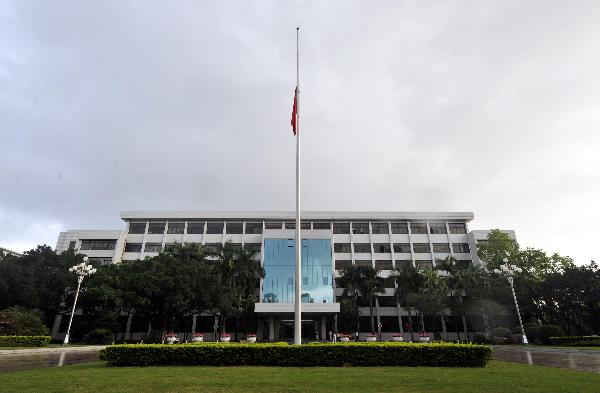 Chinese national flag on the roof of telegraph building flies at half-mast to mourn the victims of Yushu earthquake, in Beijing, China, April 21, 2010