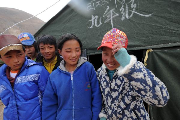 Students chat outside tents which are used as classrooms in Yushu, northwest China's Qinghai Province, April 20, 2010.