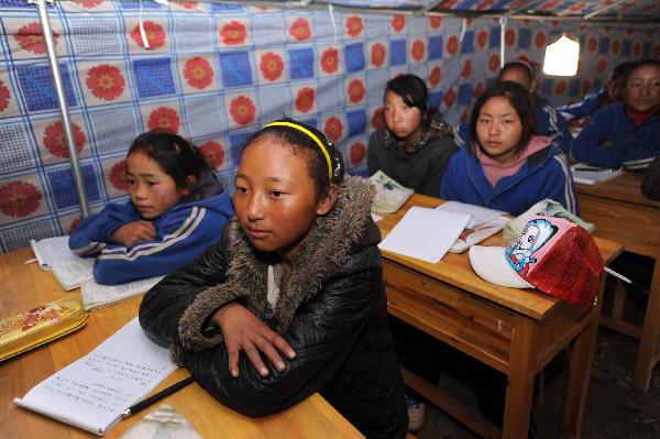 Baima (front) and her classmates have a class in a tent in Yushu, northwest China's Qinghai Province, April 20, 2010.
