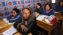 Baima (front) and her classmates have a class in a tent in Yushu, northwest China's Qinghai Province, April 20, 2010.
