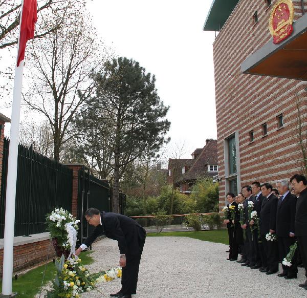 Chinese Ambassador to the Netherlands Zhang Jun (L) places a wreath as staff members of the Chinese Embassy to the Netherlands mourn for the victims of Yushu earthquake in northwest China, at the embassy to the Netherlands, April 21, 2010. 