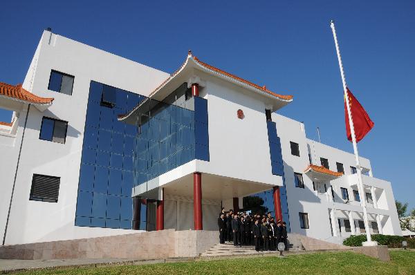 Chinese national flag flies at half mast as staff members of the Chinese Embassy to Tunisia mourn for the victims of Yushu earthquake in northwest China, at the embassy in Tunis, capital of Tunisia, April 21, 2010.