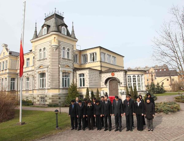Chinese national flag flies at half mast as staff members of the Chinese Embassy to Latvia mourn for the victims of Yushu earthquake in northwest China, at the embassy in Riga, capital of Latvia, April 21, 2010.