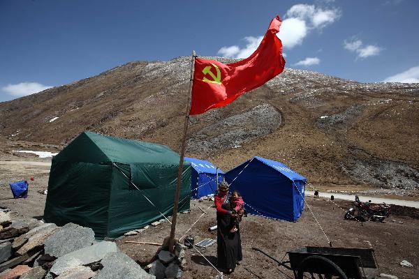 A herdman stands at tent area in the quake-hit Tibetan Autonomous Prefecture of Yushu, northwest China's Qinghai Province, April 22, 2010. 