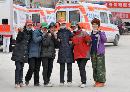 Six female volunteers pose for a photo in Yushu, Northwest China's Qinghai Province on April 21, 2010. 