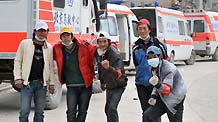 Five male volunteers pose for a photo in Yushu, Northwest China's Qinghai Province on April 21, 2010.