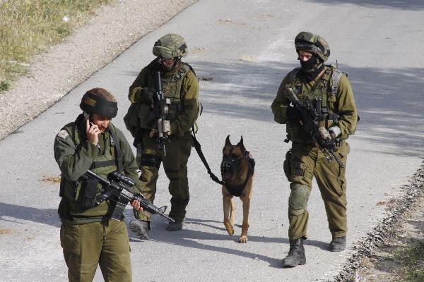 Israeli soldiers take position during clashes with Palestinian protesters in the West Bank village of Beit Awwa, near Hebron April 26, 2010.