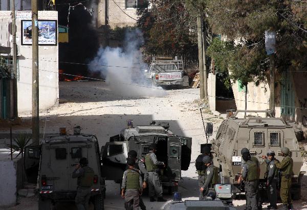 Israeli soldiers take position during clashes with Palestinian protesters in the West Bank village of Beit Awwa, near Hebron April 26, 2010. 