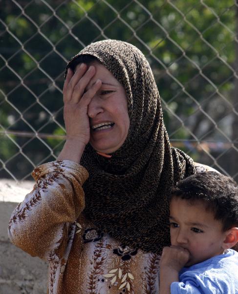 A relative of Hamas militant Ali Al-Sewiti cries during his funeral in the West Bank village of Beit Awwa, near Hebron April 26, 2010. 