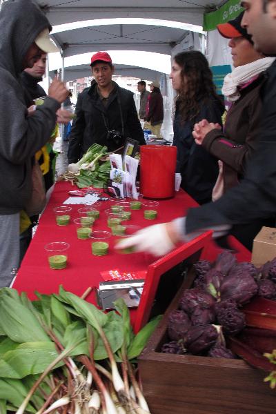 Staffs offer organic vegetable juice to the local on Union Square in New York, the United States, April 25, 2010. 