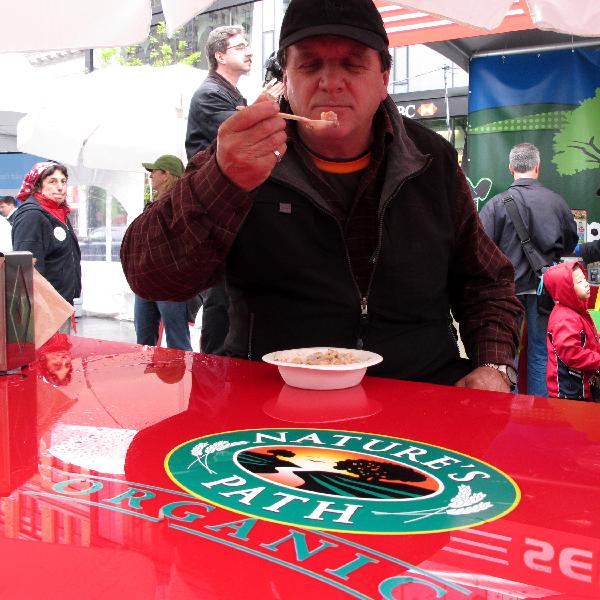 A man tries organic food on Union Square in New York, the United States, April 25, 2010. 