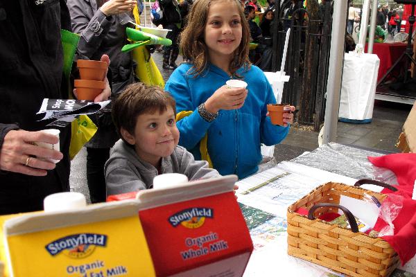 Kids drink organic milk on Union Square in New York, the United States, April 25, 2010.