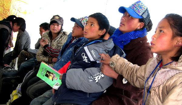 Orphans wait for an airliner at the airport of Yushu County April 26, 2010.