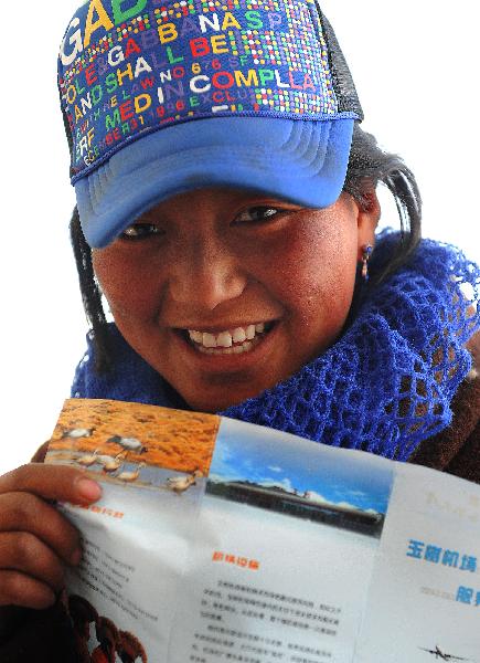 An orphan of ethnic Tibetan group reads a pamphlet while waiting for an airliner at the airport of Yushu County April 26, 2010.
