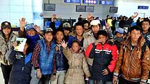Orphans pose for a group photo at Yushu Airport before departing for Xining April 26, 2010.
