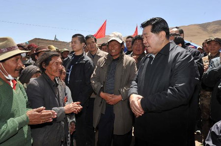 Jia Qinglin (R), chairman of the National Committee of the Chinese People's Political Consultative Conference, talks with local residents who have sufferd the earthquakes in quake-hit Yushu County, Qinghai Province, on April 26, 2010.