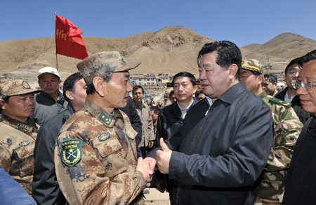 Jia Qinglin (2nd R), chairman of the National Committee of the Chinese People's Political Consultative Conference, shakes hands with a Chinese military officer in quake-hit Yushu County, Qinghai Province, on April 26, 2010.