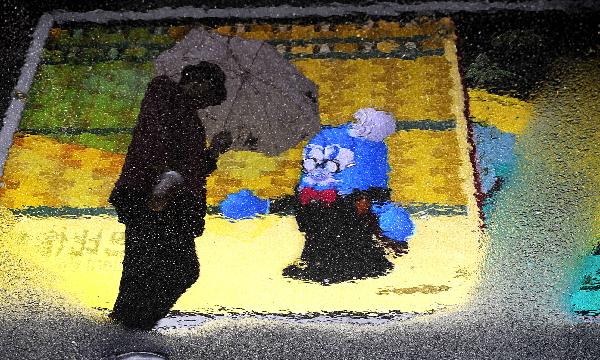 A visitor is reflected in water in the World Expo Park in Shanghai, east China, April 26, 2010.