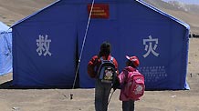 Students walk to classrooms set up in a temporary settlement in Tibet autonomous prefecture of Yushu, Qinghai Province, April 27, 2010.