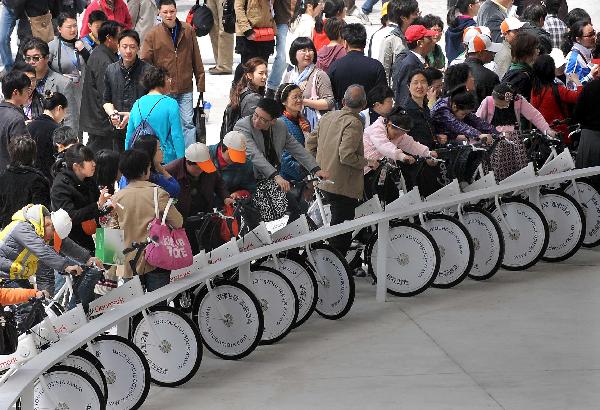 Visitors experience the special bicycle lane in the Denmark Pavilion in the World Expo Park in Shanghai, east China, April 25, 2010.