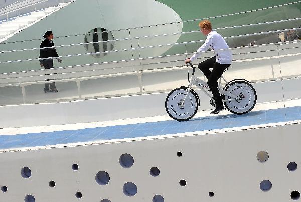An employee experiences the special bicycle lane in the Denmark Pavilion in the World Expo Park in Shanghai, east China, April 25, 2010. 