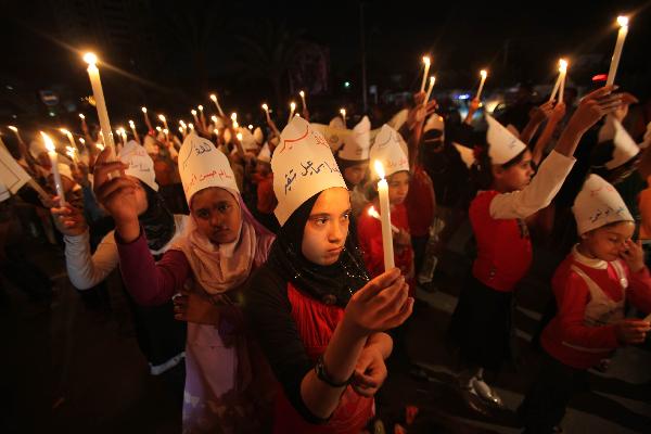 Palestinian children hold candles during a protest calling for the release of Palestinian prisoners in Gaza City, Monday, April 26, 2010. 