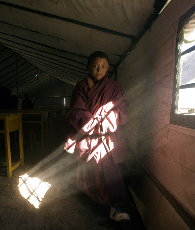 A student of Manjusri school of Thrangu Monastery walks out of tent classroom after prayer at Gyegu Town in quake-hit Tibetan Autonomous Prefecture of Yushu, northwest China&apos;s Qinghai Province, April 28, 2010.