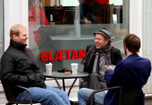 Three men chat outdoors in Reykjavik, capital of Iceland, April 28, 2010.