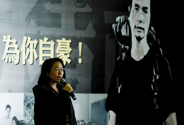 Sister of Wong Fu-wing speaks during a memorial service to honor Wong Fu-wing, a volunteer from Hong Kong who lost his life when rescuing others during the Yushu quake in southwest China's Qinghai Province, in Hong Kong, south China, April 28, 2010.