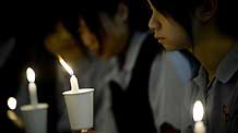 Students attend a memorial service to honor Wong Fu-wing, a volunteer from Hong Kong who lost his life when rescuing others during the Yushu quake in southwest China's Qinghai Province, in Hong Kong, south China, April 28, 2010.