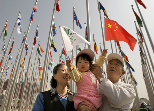 A little girl and her grandparents visit the flags square at the World Expo Park in Shanghai, east China, April 30, 2010. 