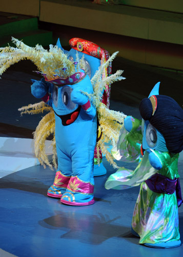 Costumed mascots of Shanghai World Expo 'Haibao' wave to spectators in the pre-ceremony performance ahead of the opening ceremony for the Shanghai World Expo at the Expo Cultural Center in Shanghai, east China, April 30, 2010. 