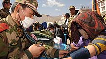 Members of the Xining detachment of the armed police force offer free diagnostic services in quake-hit Yushu County, northwest China's Qinghai Province, May 1, 2010.