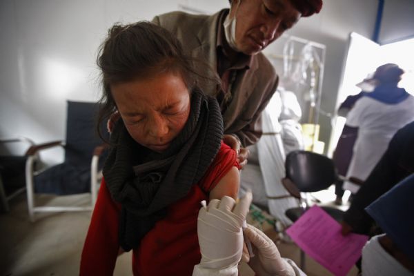 A child is vaccinated in Jiegu Town of northwest China's quake-hit Yushu Prefecture, on May 3, 2010. Over 2,500 children aged 0 to 12 have been vaccinated against measles, parotitis, rubella and hepatitis B so far in Yushu. A total of 6,000 to 7,000 children will be vaccinated. 
