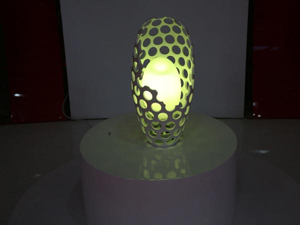 The table lamp can change its colour based on signals.