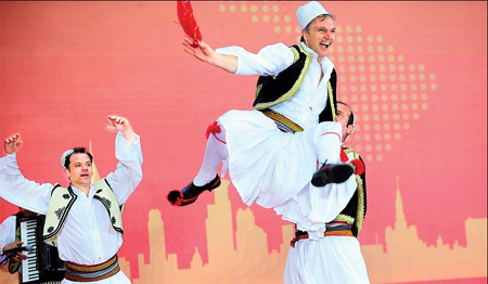 Actors perform folk songs and dances to celebrate Albania National Day at the Albania Pavilion on Wednesday. 