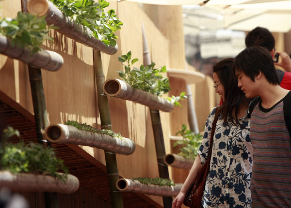Visitors look at flower pots made of bamboos in the Indonesia Pavilion in the World Expo in Shanghai, east China, on May 3, 2010. 