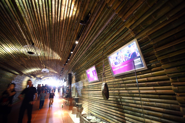 Visitors take a tour on the exhibiting passage decorated with bamboos in the Indonesia Pavilion in the World Expo in Shanghai, east China, on May 3, 2010.