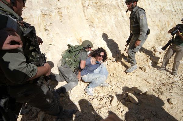 Israeli soldiers detain a protester during a demonstration by Palestinian and foreign peace activists against Israel&apos;s controversial separation barrier in the West Bank village of Walajeh, near Bethlehem, May 6, 2010. 