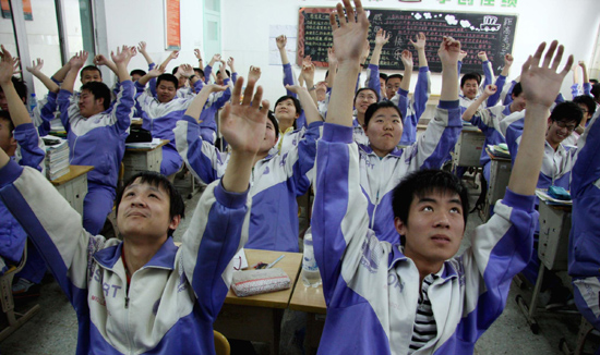 Students exercise as they undergo the intensive preparation for the national college entrance examination at a high school in Jinan, East China's Shandong Province, May 6, 2010. 