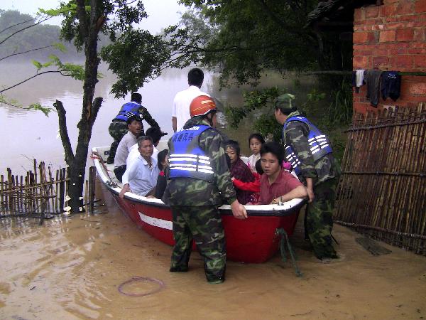 People are helped to transfer to safe places in Yingde City, south China&apos;s Guangdong Province, May 7, 2010. Heavy rainstorm hit Guangdong Province from Wednesday has left six people dead and three others missing up to 1:00 PM local time on Friday and over 50,000 people have been transferred to safe places.